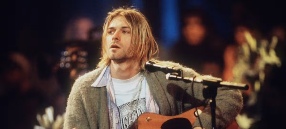 Cobain splits a guard's head with his guitar and takes a punch in Dallas
